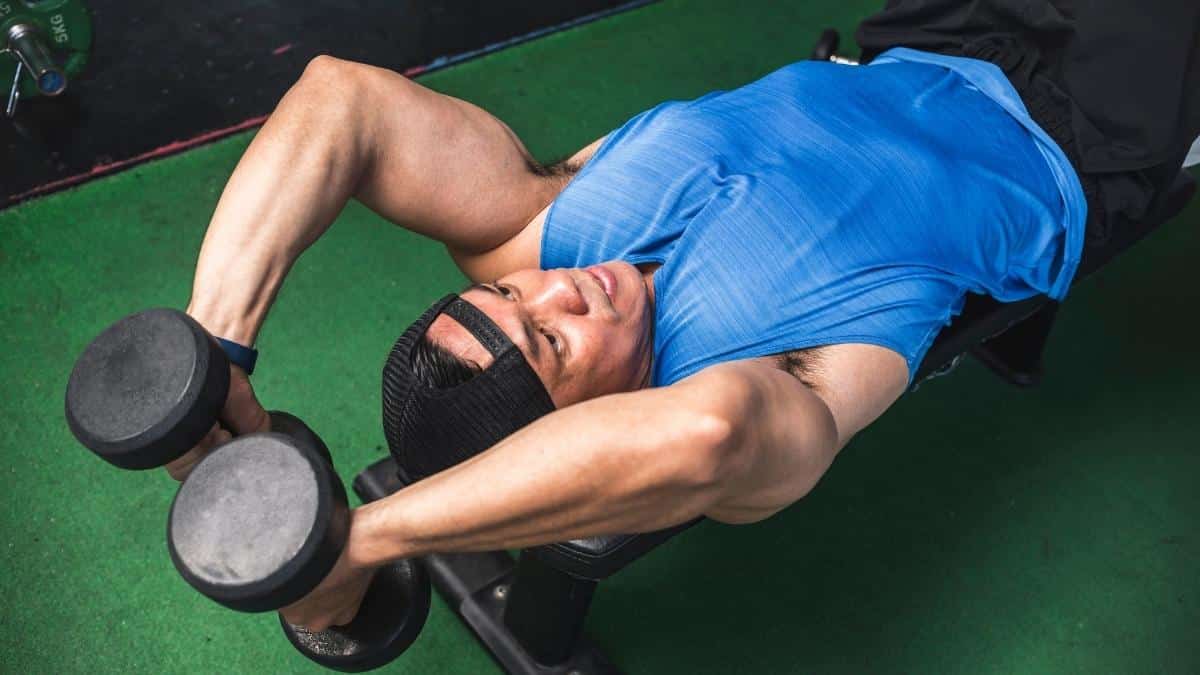 Man doing lying tricep extensions